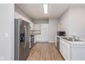 Well-lit kitchen with stainless steel appliances, white cabinetry, and plenty of counter space for food preparation at 1616 Capra Ct, Beech Grove, IN 46107