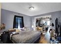 This primary bedroom includes a doorway to the kitchen and an adjoined sitting room with hardwood floors at 1719 Dawson St, Indianapolis, IN 46203