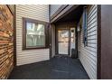 Inviting front porch with stylish black carpeting, brick accents, and a charming entry door at 1720 Justin Ct, Indianapolis, IN 46219