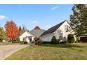 Beautiful brick home with lush green lawn, mature trees, and a three-car garage at 1853 Water Oak Ct, Avon, IN 46123