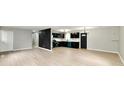 Open-concept living space with sleek floors connecting to the updated kitchen at 1965 Churchill Rd, Franklin, IN 46131