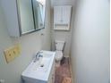 Compact bathroom featuring a vanity, toilet, medicine cabinet and neutral color scheme at 2109 N Janney Ave, Muncie, IN 47304
