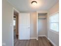 Cozy bedroom with wood floors, a closet, and a window letting in natural light at 2109 N Janney Ave, Muncie, IN 47304