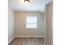 Light-filled bedroom with wood flooring, a closet, and a window at 2109 N Janney Ave, Muncie, IN 47304