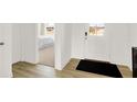 Clean entryway with wood flooring, a welcoming door, and a view into a bedroom at 2212 Foothill Dr, Greenfield, IN 46140