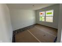 Well-lit bedroom with a large window and fresh, white paint, ready for personalization at 24517 Wallace St, Sheridan, IN 46069