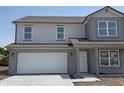 Stylish two-story home featuring a two-car garage, white door, and complementary gray siding at 24517 Wallace St, Sheridan, IN 46069