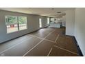 Bright, open-concept living space featuring large windows and a view into the kitchen at 24517 Wallace St, Sheridan, IN 46069