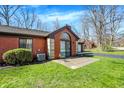 Rear of brick house with large windows and a concrete patio, perfect for outdoor living at 2979 Amherst St, Indianapolis, IN 46268