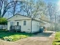 Cozy single-story home with a driveway and a well-maintained front lawn at 301 Barton Ave, Indianapolis, IN 46241