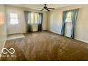 Bright living room with large windows, neutral walls, and comfortable carpeting at 301 Barton Ave, Indianapolis, IN 46241