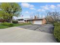 Exterior view of a home with a driveway, lawn, and American flag in the front yard at 318 Camby St, Greenwood, IN 46142