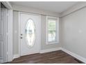 Welcoming entryway featuring stylish front door, window, and laminate floors at 3241 N Capitol Ave, Indianapolis, IN 46208