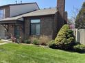 A well-maintained townhouse with a brick facade and manicured front lawn at 346 E St Clair E St, Indianapolis, IN 46202