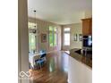 Cozy dining area with hardwood floors, chandelier and large windows offering natural light at 3504 Inverness Blvd, Carmel, IN 46032