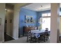 Elegant dining room with blue walls, chandelier, and a window with natural light for a warm ambiance at 3504 Inverness Blvd, Carmel, IN 46032