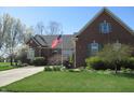 Beautifully landscaped brick home with lush greenery and a welcoming facade on a sunny day at 3504 Inverness Blvd, Carmel, IN 46032
