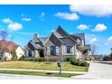 Attractive home featuring stone and siding, set on a well-kept lawn with established landscaping at 3582 Pete Dye Blvd, Carmel, IN 46033