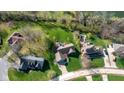 An aerial view of a residential area, showing multiple homes with lush lawns and tree coverage at 4063 Millstream Rd, Greenwood, IN 46143