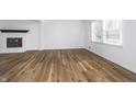 Bright living room featuring a fireplace, hardwood floors, and large windows at 4106 Armon Ct, Carmel, IN 46033