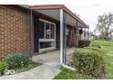 Inviting covered porch with brick detailing and manicured bushes at 438 Park Dr, Greenwood, IN 46143