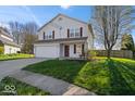 Traditional two-story home with a well-manicured lawn, attached garage, and inviting curb appeal at 4613 Walker St, Greenwood, IN 46143