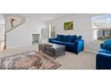 Bright living room with blue sofas, plush carpet, and lots of natural light at 4613 Walker St, Greenwood, IN 46143