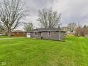 Charming single-story home featuring an attached garage and a well-maintained front yard with mature trees at 4715 Southern Ave, Anderson, IN 46013
