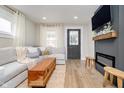 Cozy living room boasts a modern fireplace, plush seating, and plenty of natural light at 4719 Evanston Ave, Indianapolis, IN 46205
