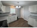 Well-lit kitchen features white cabinets, modern countertops, and sleek appliances at 4823 Atwell Dr, Lawrence, IN 46226