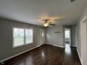 Spacious living room with wood-look floors, a ceiling fan, and a view of other rooms in the home at 4823 Atwell Dr, Lawrence, IN 46226