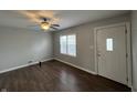 Bright living room with wood-look floors, a ceiling fan, and windows, creating a welcoming atmosphere at 4823 Atwell Dr, Lawrence, IN 46226