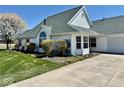 Beautiful white home with lush green lawn and meticulously landscaped front yard at 5129 W Preakness Ct, Muncie, IN 47304