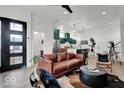 Inviting living room featuring a stylish leather sofa, modern lighting, and an open layout at 514 Spruce St, Indianapolis, IN 46203
