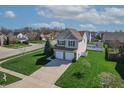 Well-manicured lawn and a two-car garage enhance this inviting two-story home at 5209 Twin Bridge Blvd, Indianapolis, IN 46239