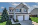 Charming home with a two-car garage, set on a beautifully landscaped lawn at 5209 Twin Bridge Blvd, Indianapolis, IN 46239