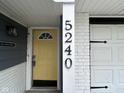 Close-up of the front door with yellow paint and house number 5240 at 5240 Regency Dr, Columbus, IN 47203