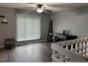 Comfortable living room featuring a ceiling fan, hardwood floors, and neutral wall paint at 5240 Regency Dr, Columbus, IN 47203