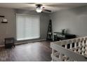 Cozy living room with hardwood floors, a ceiling fan, and ample natural light at 5240 Regency Dr, Columbus, IN 47203