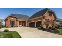 Charming brick home with a spacious driveway and a two-car garage at 528 Dylan Dr, Carmel, IN 46032