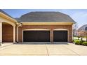 Lovely two-car garage with a spacious driveway and a well-manicured lawn at 528 Dylan Dr, Carmel, IN 46032