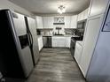 Bright kitchen with stainless steel appliances, white cabinetry, and sleek, dark countertops at 6225 Roberts Creek Ln, Indianapolis, IN 46221