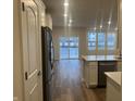 Open-concept kitchen featuring stainless steel appliances, an island, and a view of the living area at 7342 Shroyer Way, Noblesville, IN 46062
