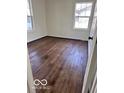 Bright bedroom features hardwood floors and natural light from two large windows at 737 S Broadway St, Pendleton, IN 46064