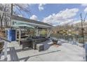 Cozy outdoor deck with comfortable seating, a fire pit, and tranquil lake views at 7668 Heather Dr, Nineveh, IN 46164
