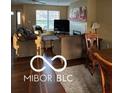 Open-concept living room with hardwood floors, a fireplace, and comfortable seating, perfect for Gathering gatherings at 804 Seabreeze Dr, Avon, IN 46123