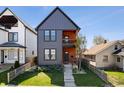 Attractive two-story home features charcoal gray siding, natural wood accents, and landscaped lawn at 807 E Minnesota St, Indianapolis, IN 46203