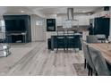Modern kitchen features white cabinets, stainless steel appliances, island with seating, and an open concept living space at 8560 E 38Th St, Indianapolis, IN 46226