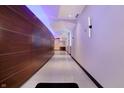 A long hallway with dark wood accent walls, modern lighting, and a sleek, contemporary design at 1 Virginia Ave # 707, Indianapolis, IN 46204