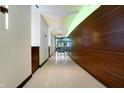 A bright hallway is decorated with wood accent walls, and modern lighting, leading to glass doors at 1 Virginia Ave # 707, Indianapolis, IN 46204